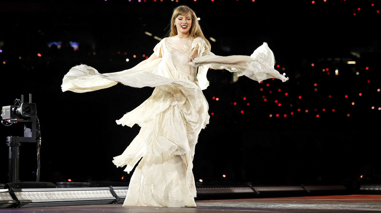 Taylor Swift onstage in a flowing white dress