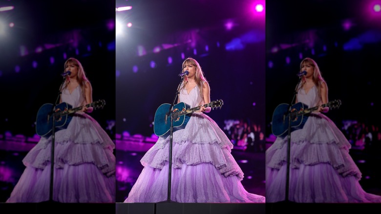 Taylor Swift onstage in a purple ballgown