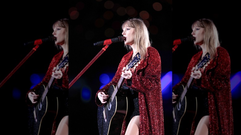 Taylor Swift on stage with a guitar