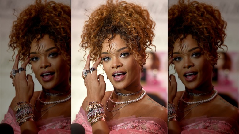 Rihanna smiling with an updo at the RiRi fragrance launch