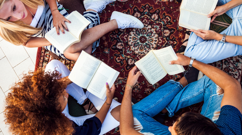 A diverse group of women are all reading together