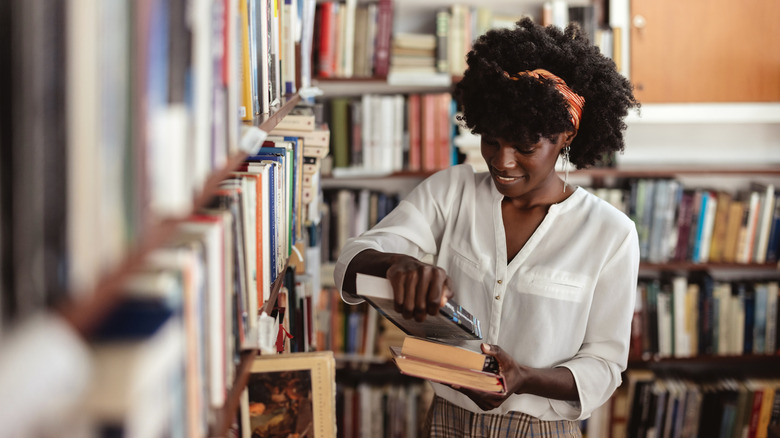 Woman smiling as she browses in a bookstore