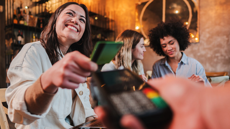 Woman paying with credit card