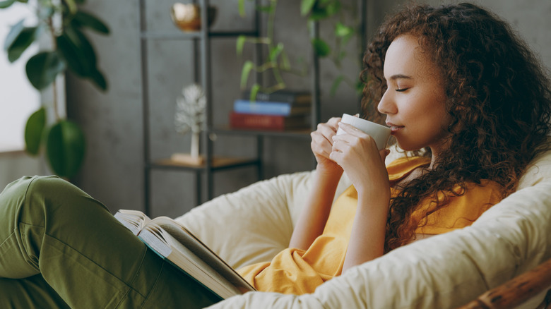 Woman reading drinking tea