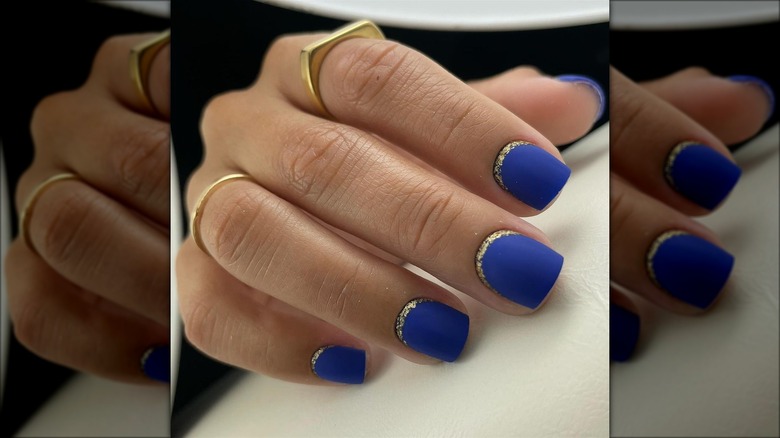 Matte blue nails with gold glitter