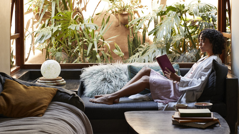 Woman reading in window