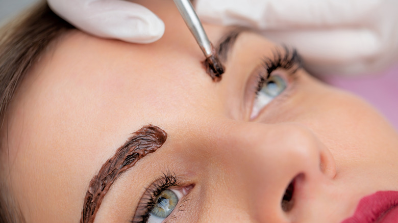 Woman receiving eyebrow tint