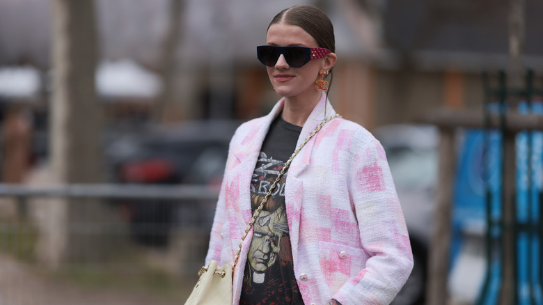 A woman in a pink boucle jacket 