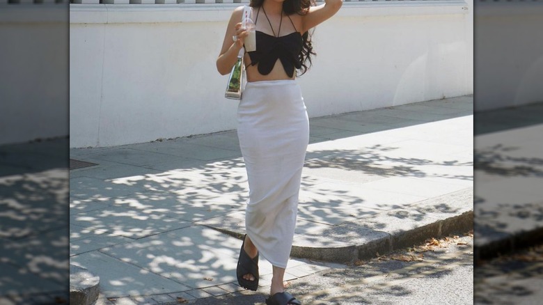 Woman in butterfly top, maxi skirt