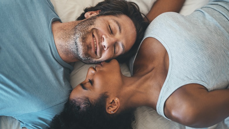 Couple in bed kissing