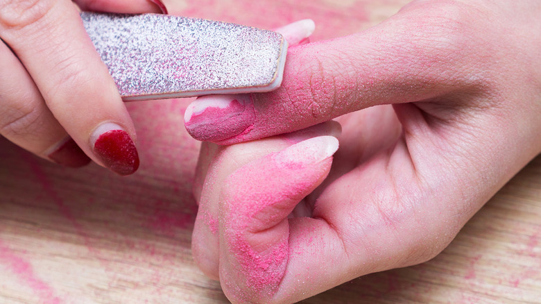 filing pink nail polish