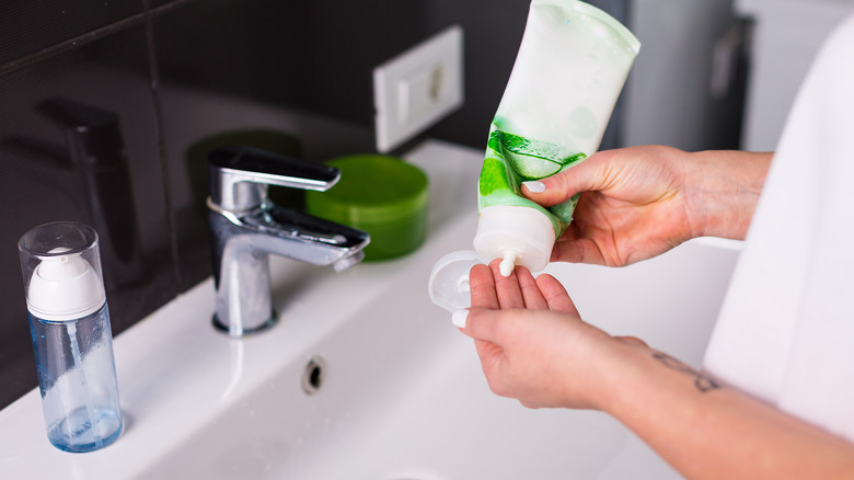 Person squeezing cleanser into hands