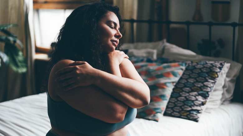 Woman hugging herself