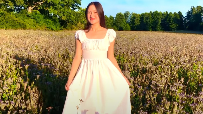 A woman on YouTube in a milkmaid dress 