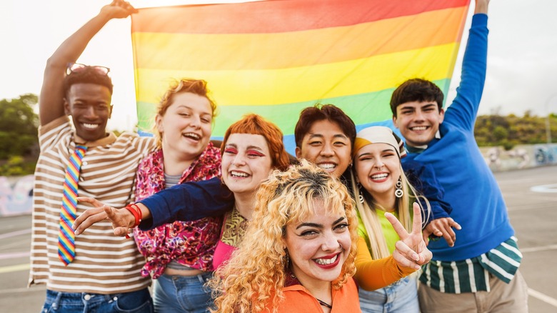 People holding rainbow flag