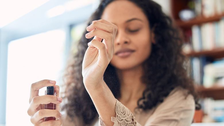 Woman applying perfume