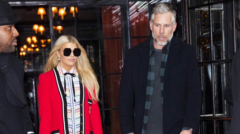 Jessica Simpson with sunglasses on and Eric Johnson in a black coat in New York City