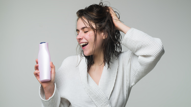A woman applying hair conditioner