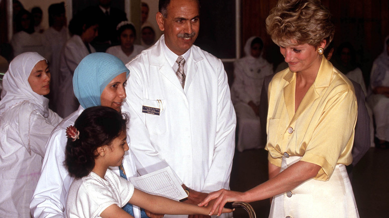 Princess Diana holding hand