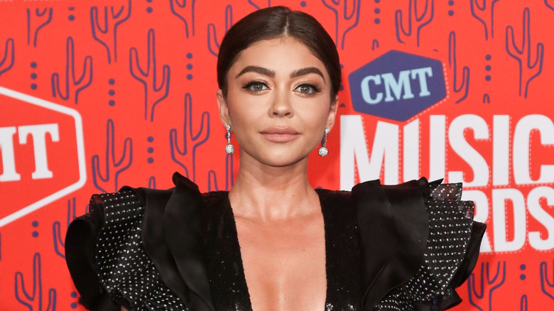 Sarah Hyland on the red carpet in a dress with large shoulders