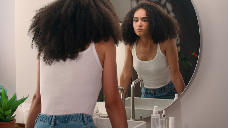 Woman looking at her reflection