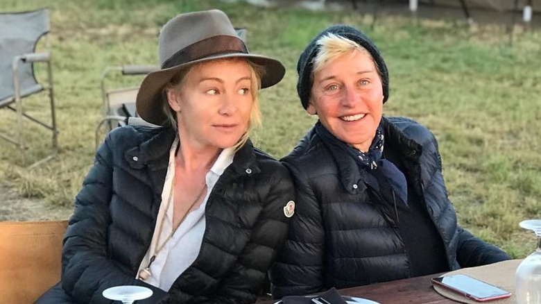 Portia De Rossi sitting with Ellen DeGeneres