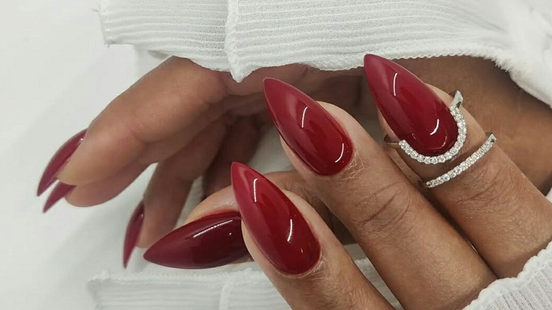 Pointy almond-shaped nails with red polish