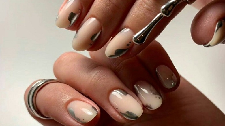 Nude manicure with silver metallic accents