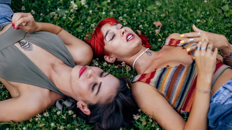 two women talking on grass
