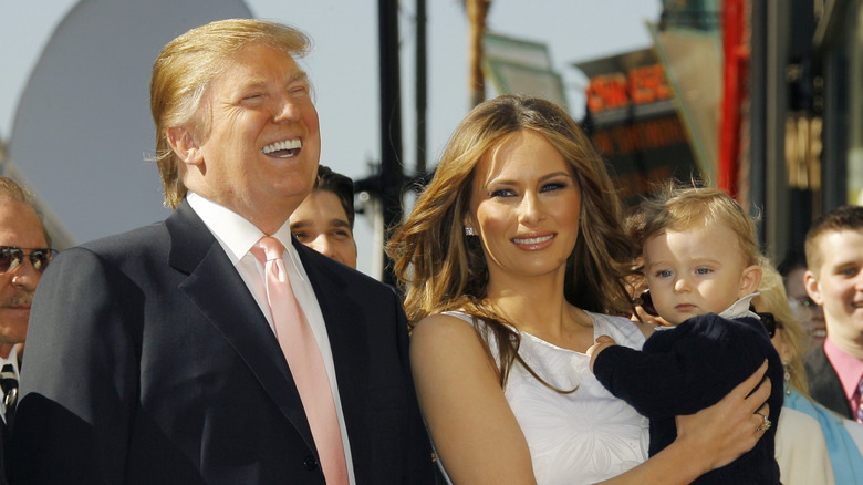 Donald, Melania, and Barron Trump at an outdoor event