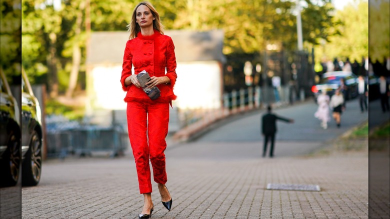 Woman in a red pant suit 