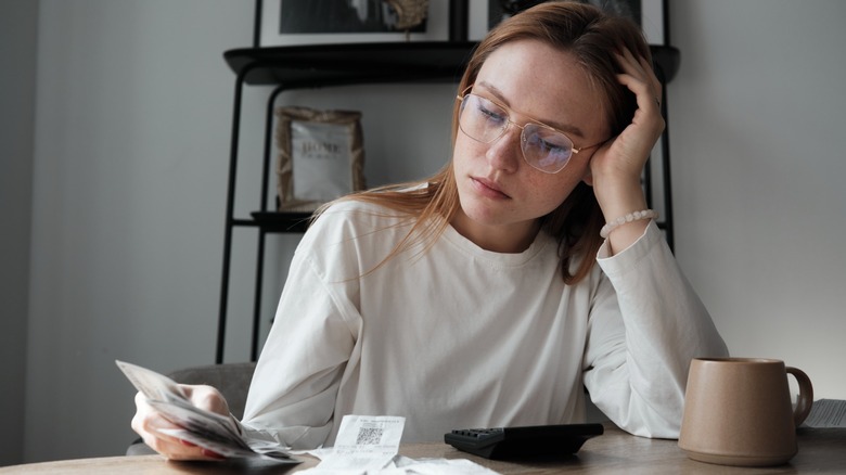 Woman looking at bills