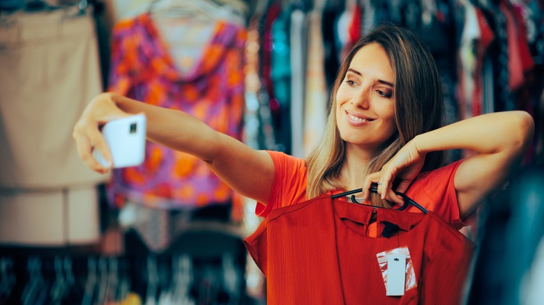 Woman taking selfie while shopping