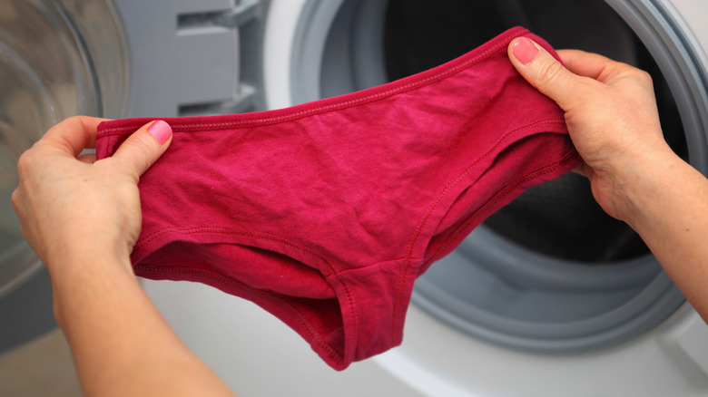 Putting underwear into washing machine