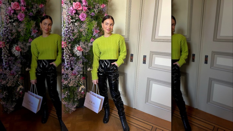 High-waisted vinyl pants paired with bright green sweater 