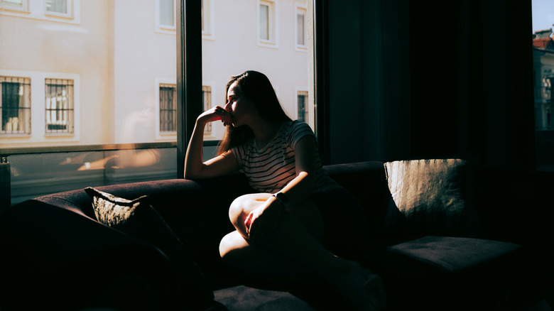 Woman stressed looking out the window