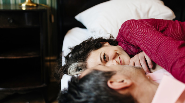 mature couple embracing in bed