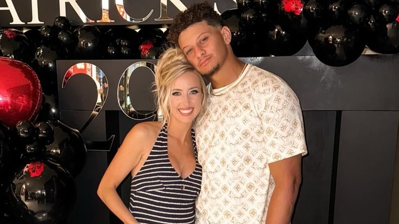 Brittany Mahomes posing with Patrick Mahomes