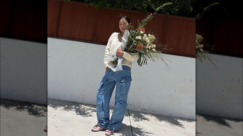 woman in slouchy jeans with flowers