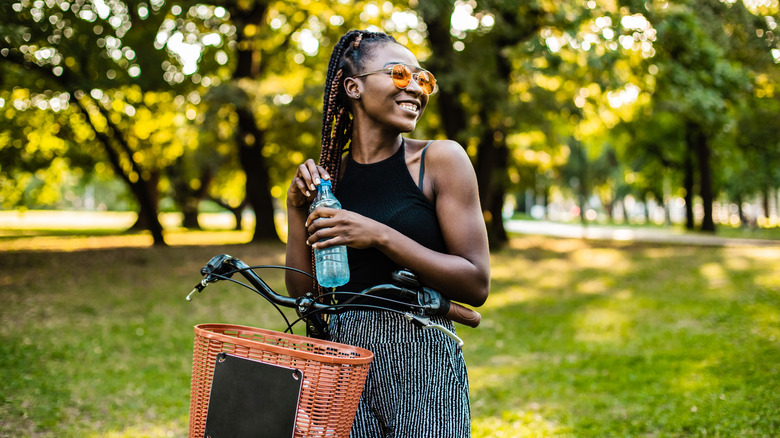 Woman on bike drinking water