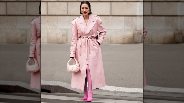 A woman in a pink leather trench coat 