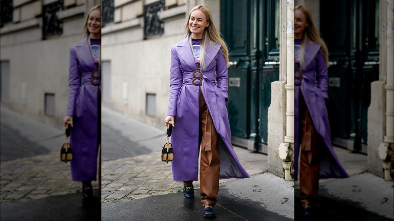 A woman in a purple leather trench coat 