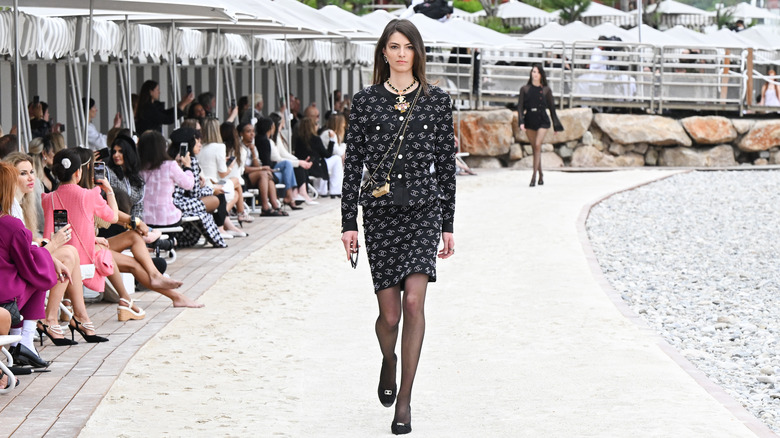 Models walk the runway at the Chanel Cruise 2023 fashion show