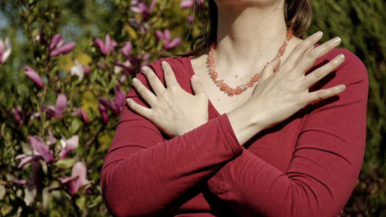 A woman tapping her chest in EMDR therapy