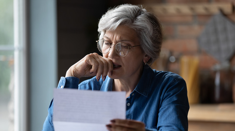 Older woman reading a letter