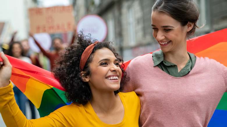 young couple holding pride flag