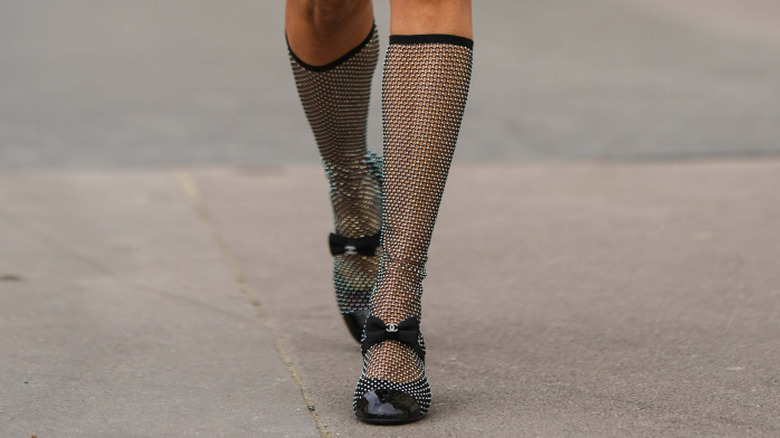 Feet with crystal mesh socks and Chanel shoes