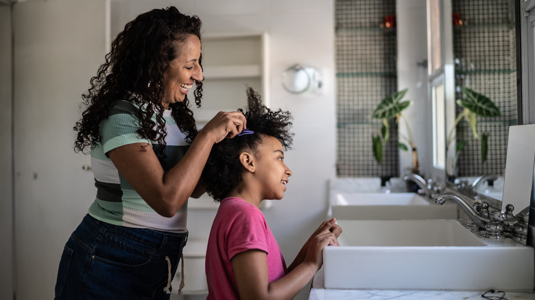 Woman does daughter's textured hair