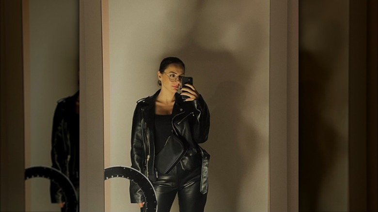 Woman wearing black T-shirt with leather pants