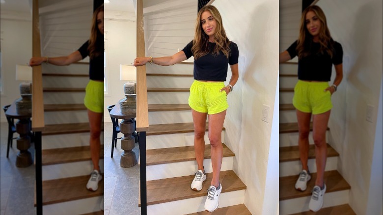 Woman wearing black T-shirt with neon shorts